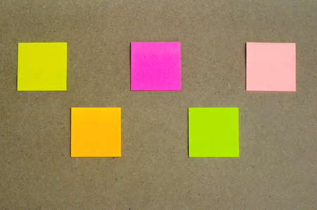 five colorful blank sticky note or empty post notes advertisement top view flat lay on cork board for reminder remember on working or appointment with customer, coworker, supplier.の写真素材