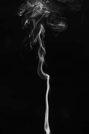 abstract fragment movement of white smoke on black background.の写真素材
