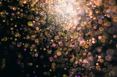 abstract bright colorful yellow and gold or magenta bokeh glitter sparkle blurred background. like molecule spread and absorb.の写真素材