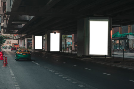 big blank billboard white LED screen vertical outstanding in the city on pathway side the road traffic with car for display advertisement text template promotion new brand at outdoor.のeditorial素材