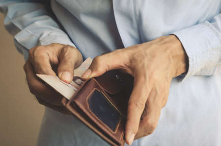 business man open show leather wallet with holding and take and pick money saving. wealth financial...