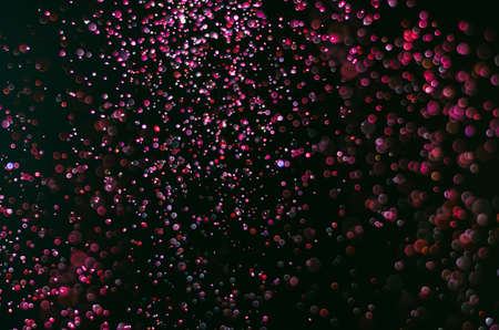 abstract bright colorful violet and red bokeh glitter sparkle blurred background. like molecule spread and absorb.の写真素材