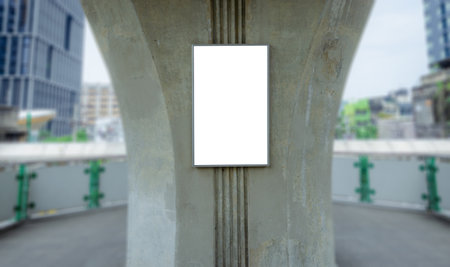 large blank advertise billboard white LED screen vertical on big concrete pole walk way outdoor in city.の写真素材