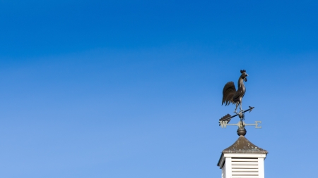Weather vane against blue skyの写真素材