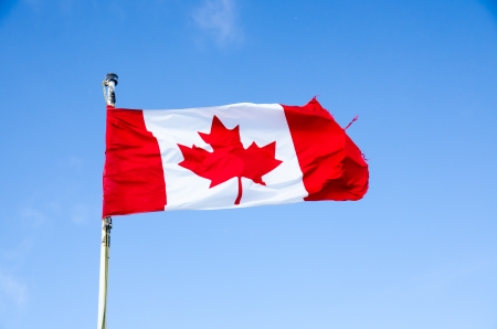 Canada flag on blue sky  backgroundの写真素材