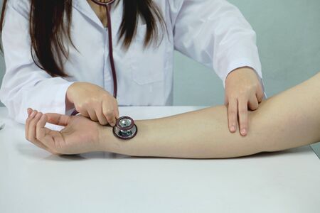 Doctors check the pulse of the patient.の写真素材