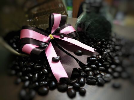 Coffee time concept. with pink ribbon on coffee beans backgroundの写真素材