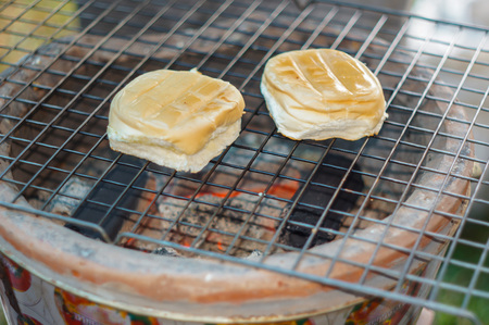 bun with egg custard toasted on  charcoal brazierの写真素材