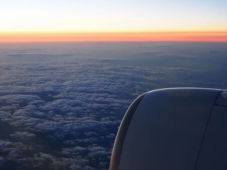 Clouds and sky through window of aircraft on night timeの写真素材