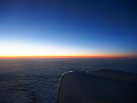 Clouds and sky through window of aircraft on night timeの写真素材