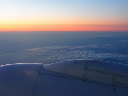 Clouds and sky sthrough window of aircraft on night timeの写真素材