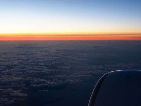 Clouds and sky sthrough window of aircraft on night timeの写真素材
