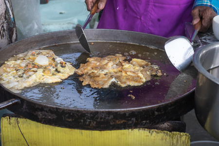 close up cooking fried sea mussels with egg,  flour in fair on urban of Thailandの写真素材