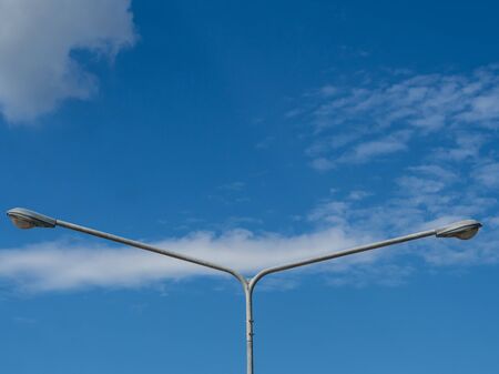electricity post duo with blue sky backgroundの写真素材