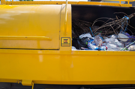 close up garbage in garbage truck and be careful signの写真素材