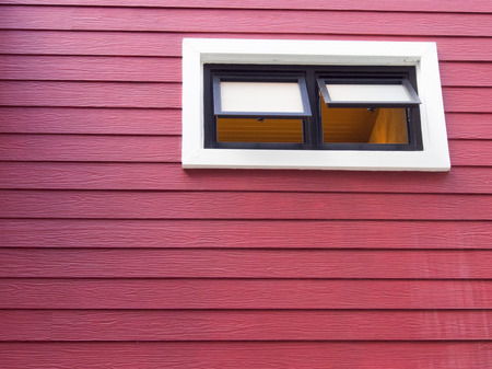 window on red wood wallの写真素材