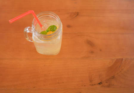 mint in a glass of ice orange juice, selective focus , top view