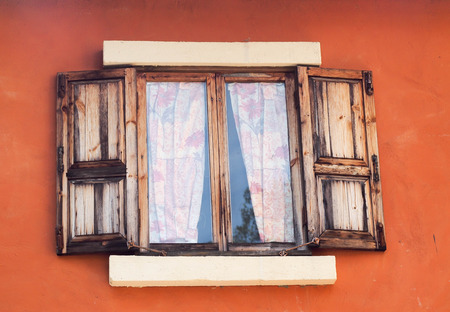 old wooden window and orange wall