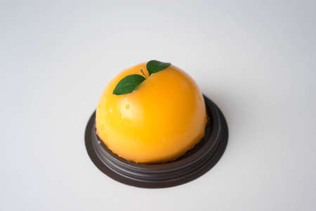 orange butter cake on plastic plate , white backgroundの写真素材