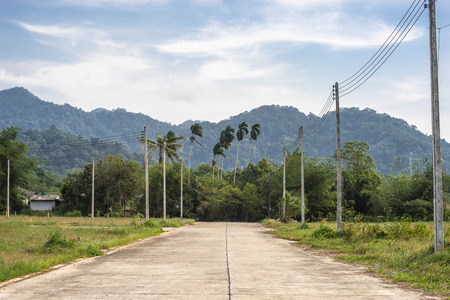 cement road and  electricity post, hil backgroundの写真素材