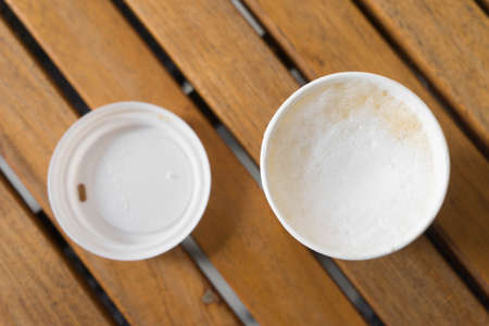 hot cappuccino in paper cup for take away on wooden tableの写真素材