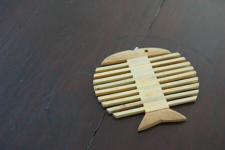 fish shape wood mat for heat supportの写真素材