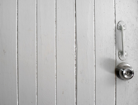 door knob and handle on white old wooden doorの写真素材