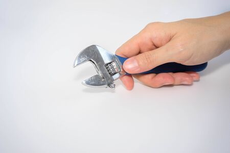 woman's hand hold adjustable wrenchの写真素材