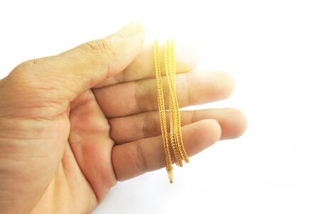 The gold neck weighs about 0.5 grams on the hand on white background.の写真素材
