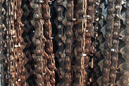 Old chainsaw rusting up overlapping.The old chain saw has expired.;の写真素材