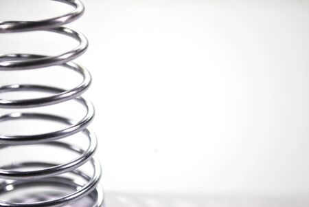 Silver spring steel wire on a white background.の写真素材