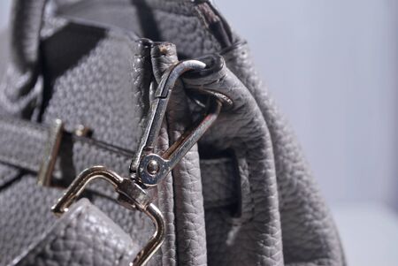 The hook on the edge of the gray leather bag.の写真素材