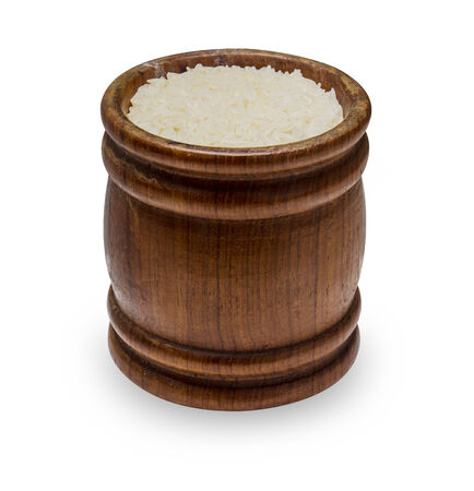 rice in a wooden bowl isolated on white backgroundの写真素材