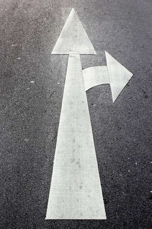 The arrow direction painted on roadの写真素材