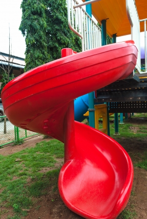 picture of red plastic slider playground object at parkの写真素材