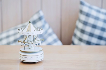 Wooden carousel on a wooden tableの素材