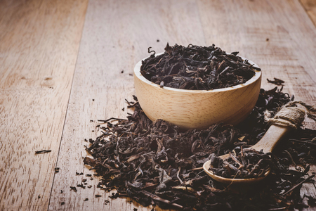 close-up of dry chinese tea in woonden bowl, vintage tone, selective focusの写真素材