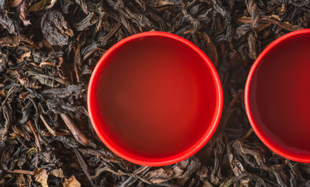 close-up of a cup of chinese tea on dry tea leaves backgroundの写真素材