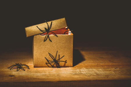 close-up of mysterious horror box on wooden table, with spiders climb around a box decoration idea, halloween conceptの写真素材