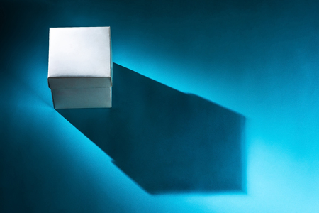 white box on blue background with shadowの写真素材
