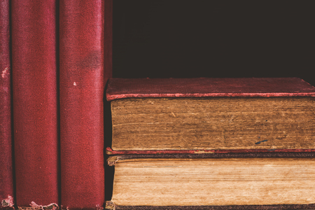 close-up pile of old books on black backgroundの写真素材