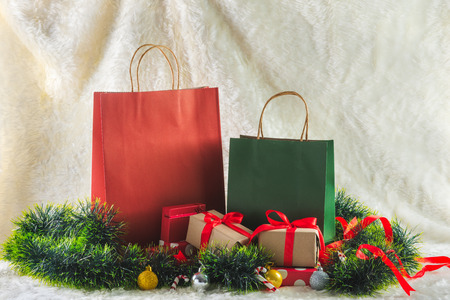 shopping bag and gift boxes decorated with ornaments on woolの写真素材