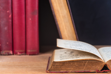 close-up of old book open on wooden table