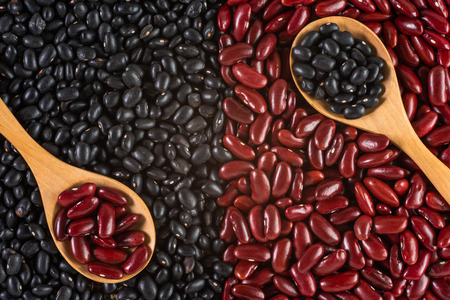 red and black beans in wooden spoon, top viewの写真素材