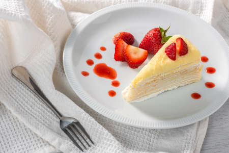 piece of strawberry cake dessert and sauce topping on white dishの写真素材