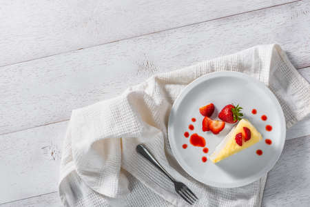 piece of strawberry cake dessert and sauce topping on white dish, top viewの写真素材