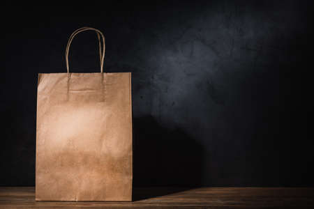craft paper shopping bag on wooden tableの写真素材