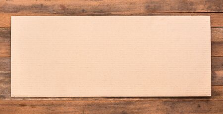 blank corrugated paper on grunge wooden table