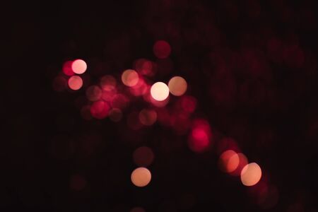 Abstract blurred light red bokeh on dark background