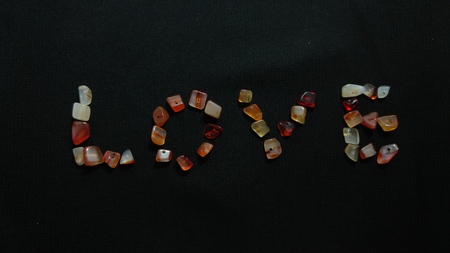 Word love with colored beads on black backgroundの写真素材